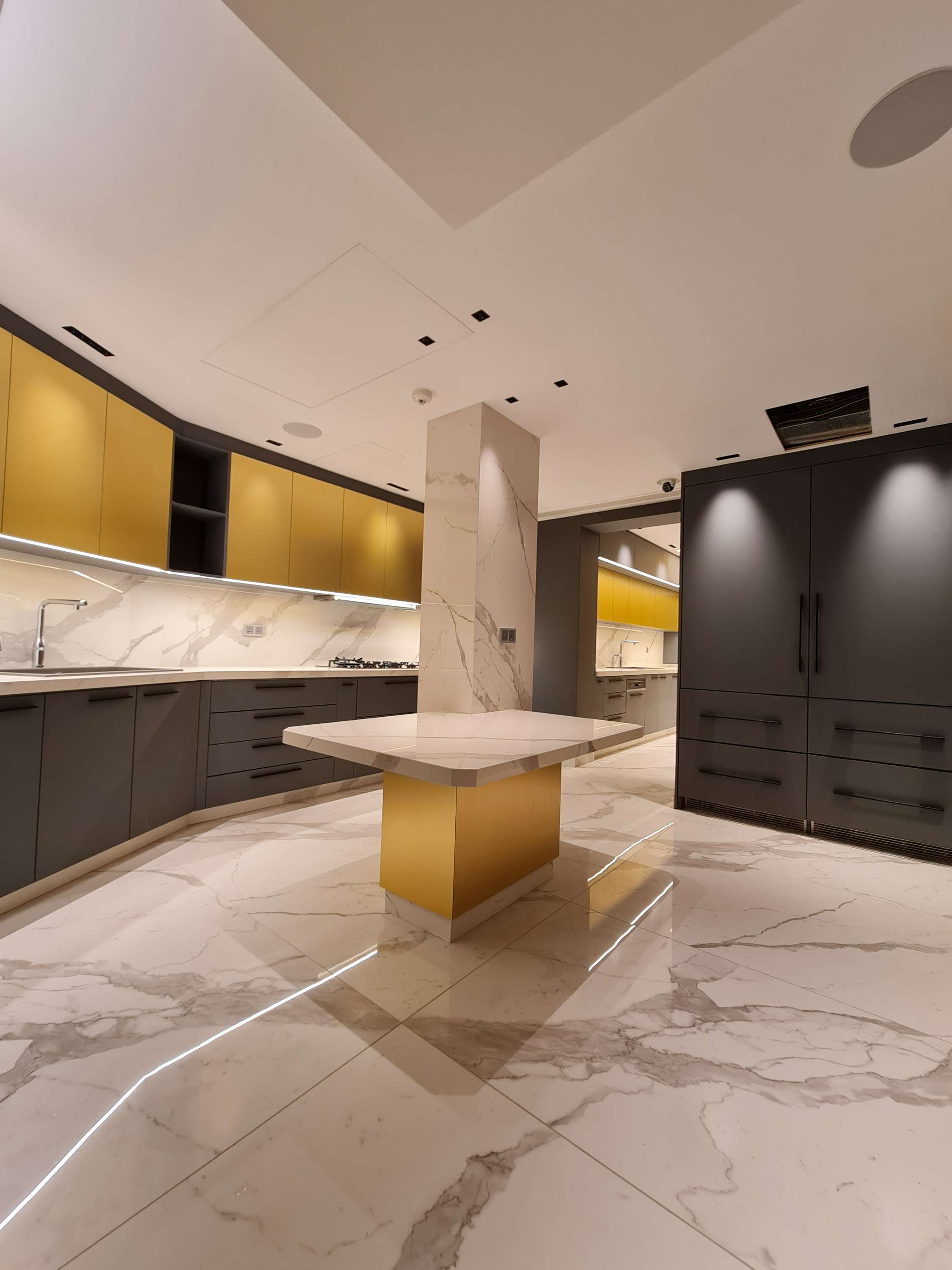 Sleek kitchen with custom cabinetry and high-end appliances by La Fabriqua