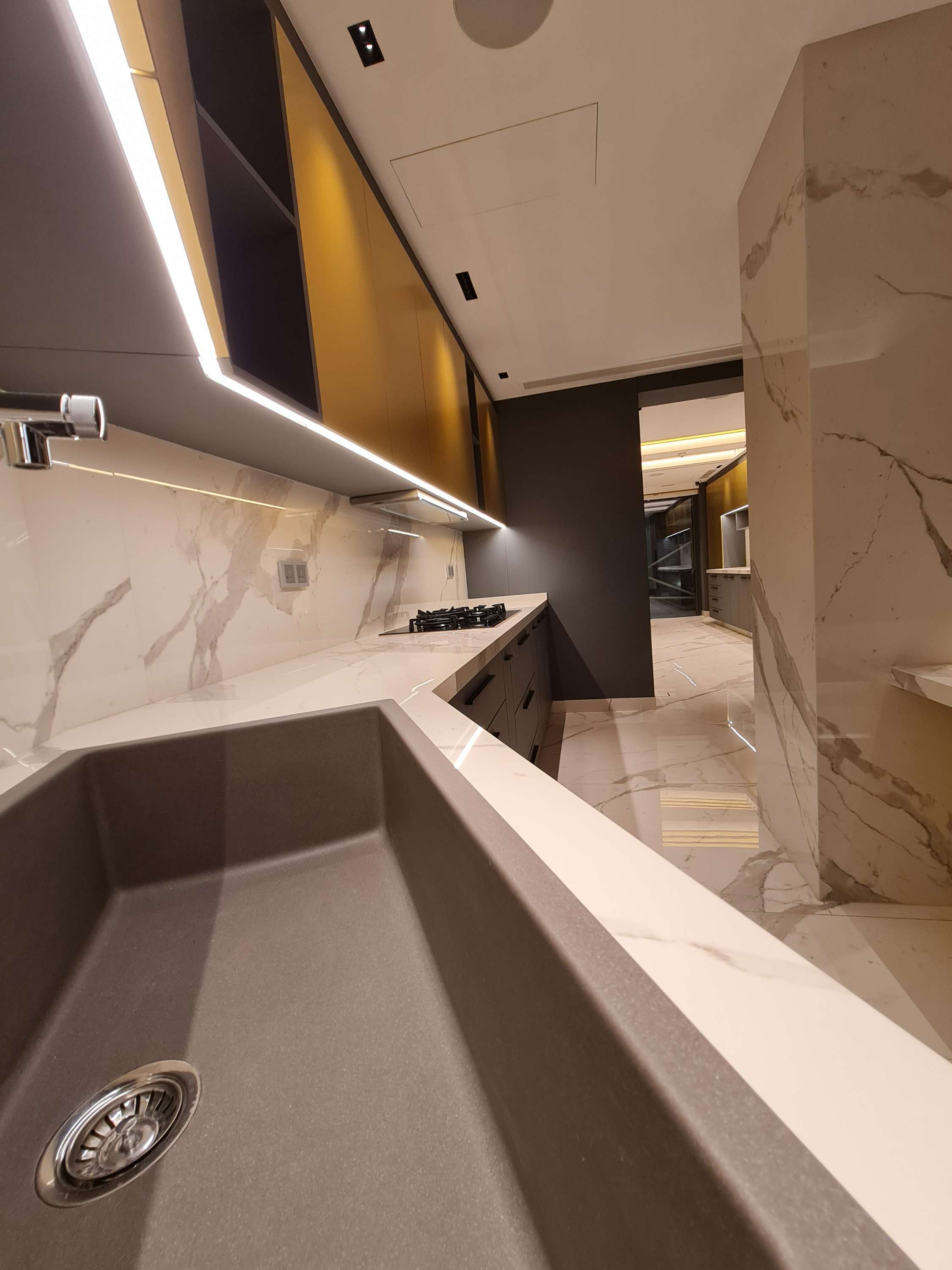 Minimalist kitchen with clean lines and integrated storage solutions by La Fabriqua