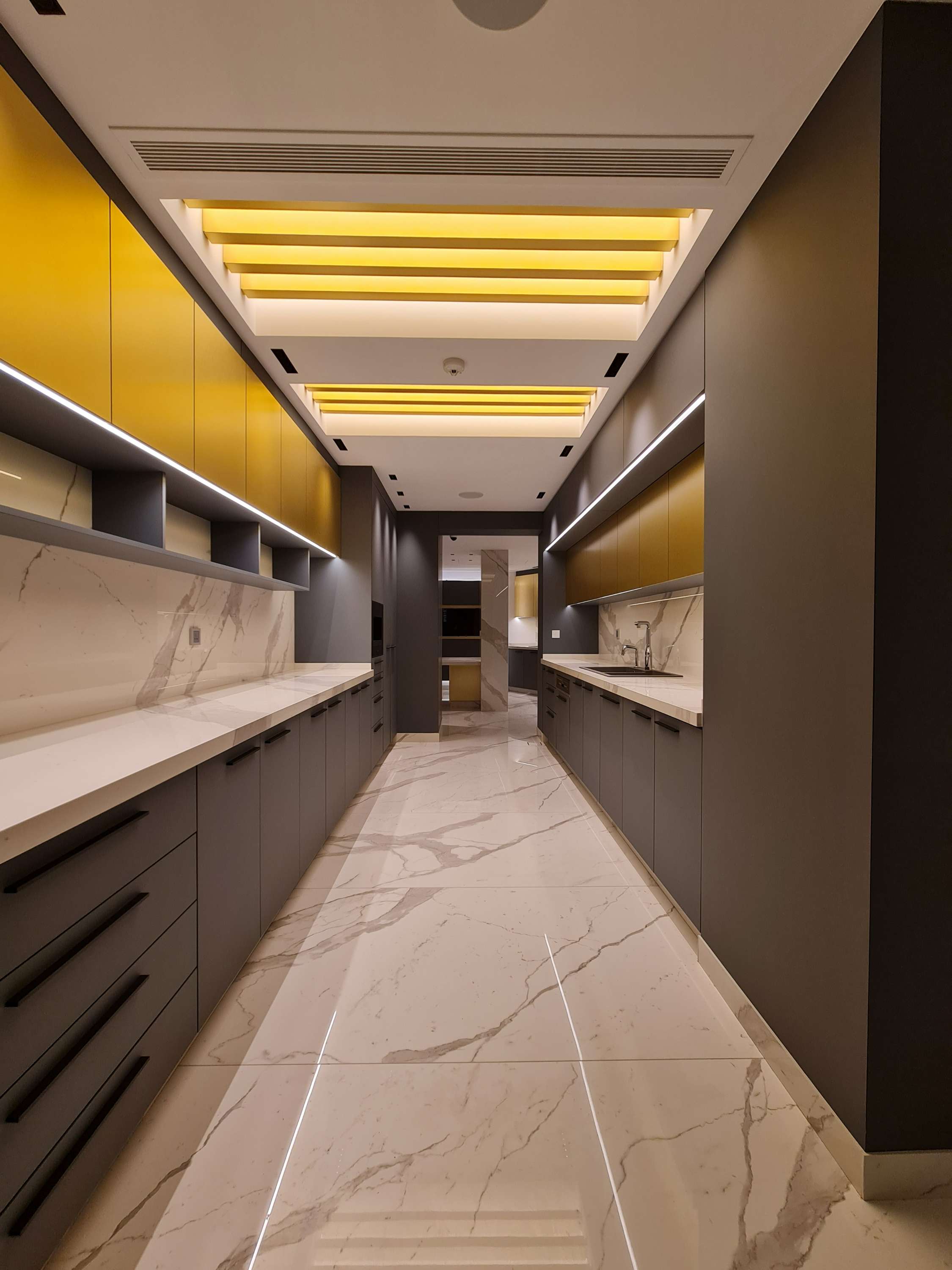 Sophisticated kitchen layout with contrasting black and white elements by La Fabriqua