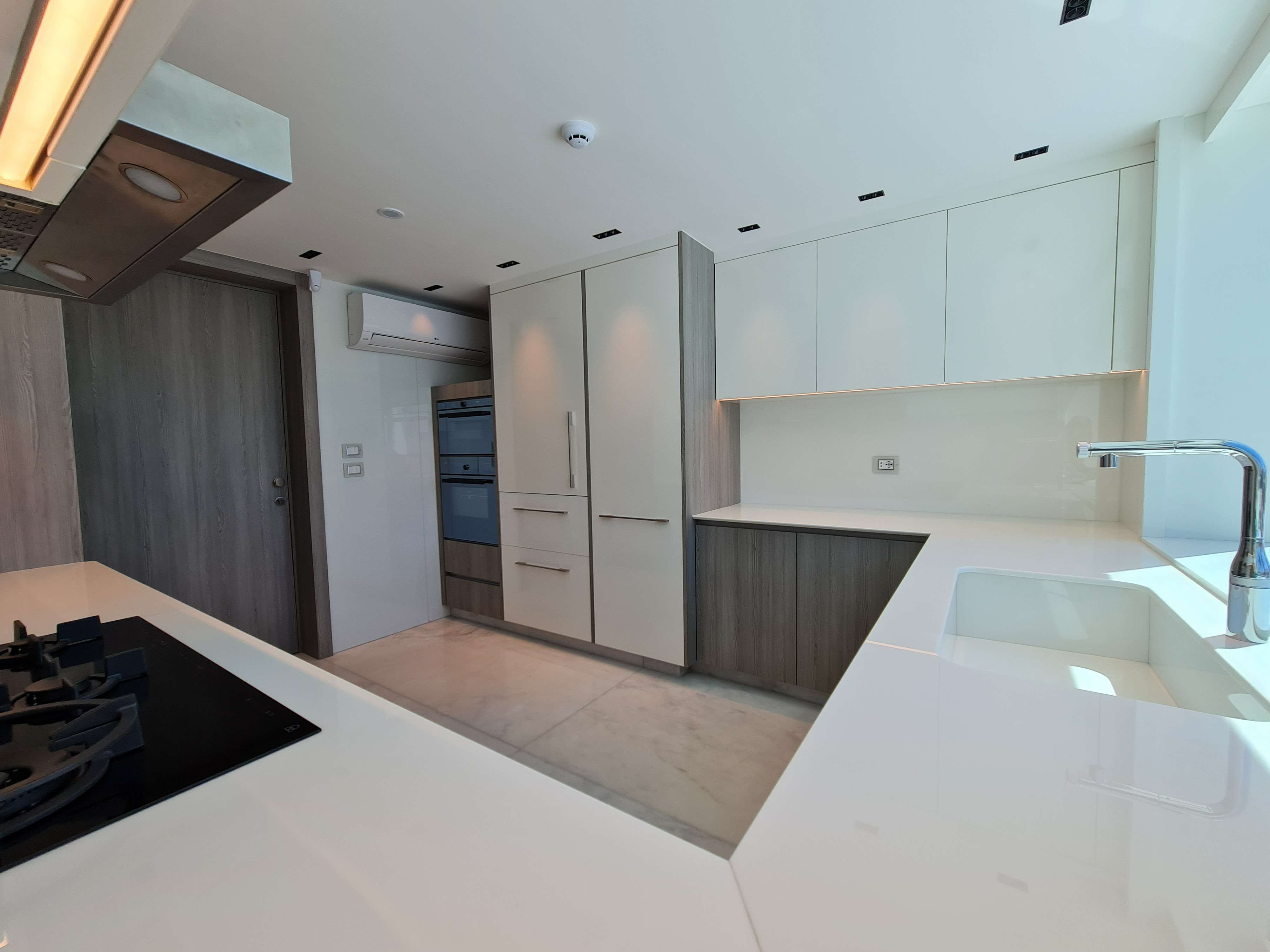 Elegant kitchen featuring a sleek island and sophisticated finishes by La Fabriqua