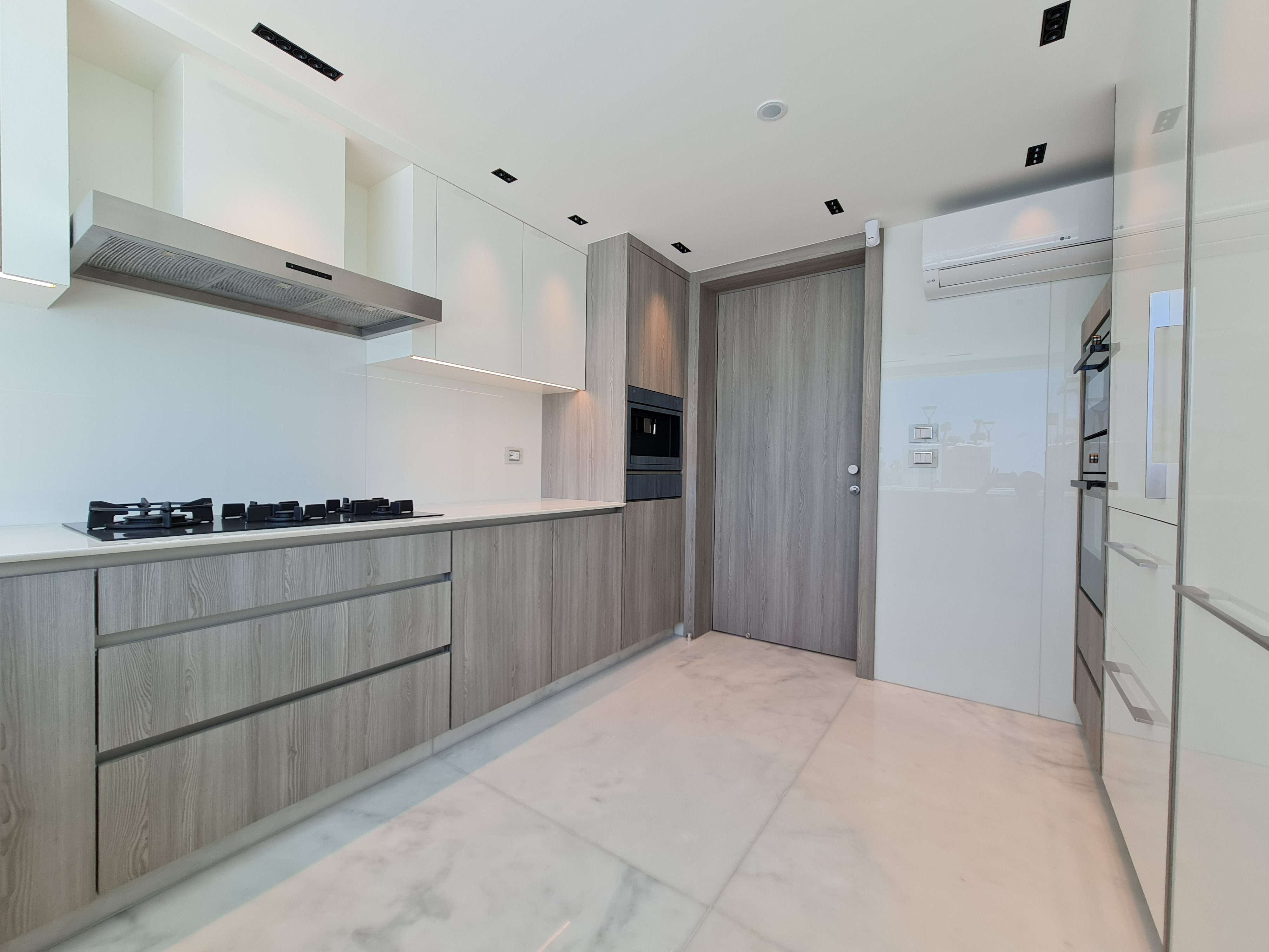 Luxury kitchen space with custom shelving and high-end fixtures by La Fabriqua