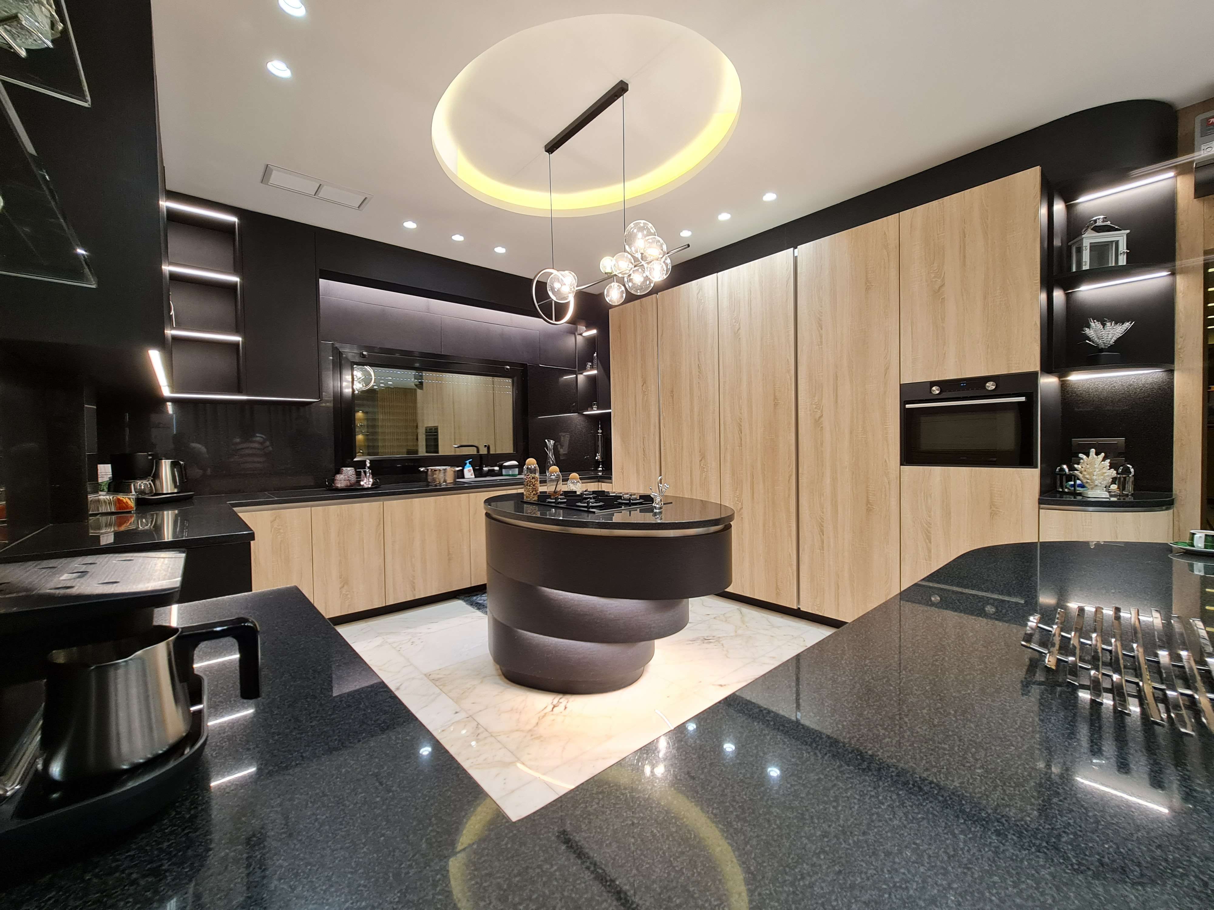 Contemporary kitchen with a dynamic color scheme and custom cabinetry by La Fabriqua