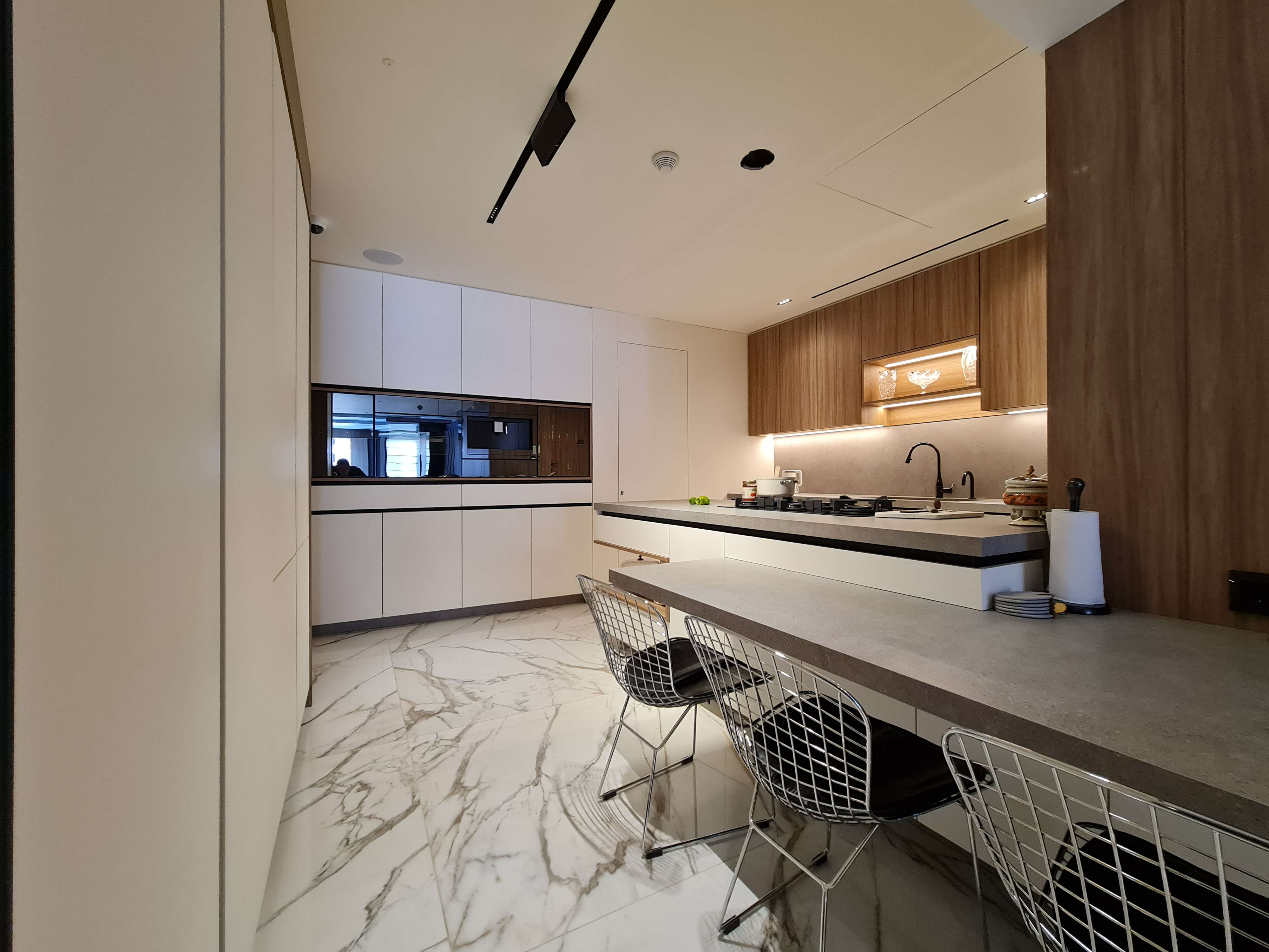 Modern kitchen with clean lines and high-end appliances by La Fabriqua