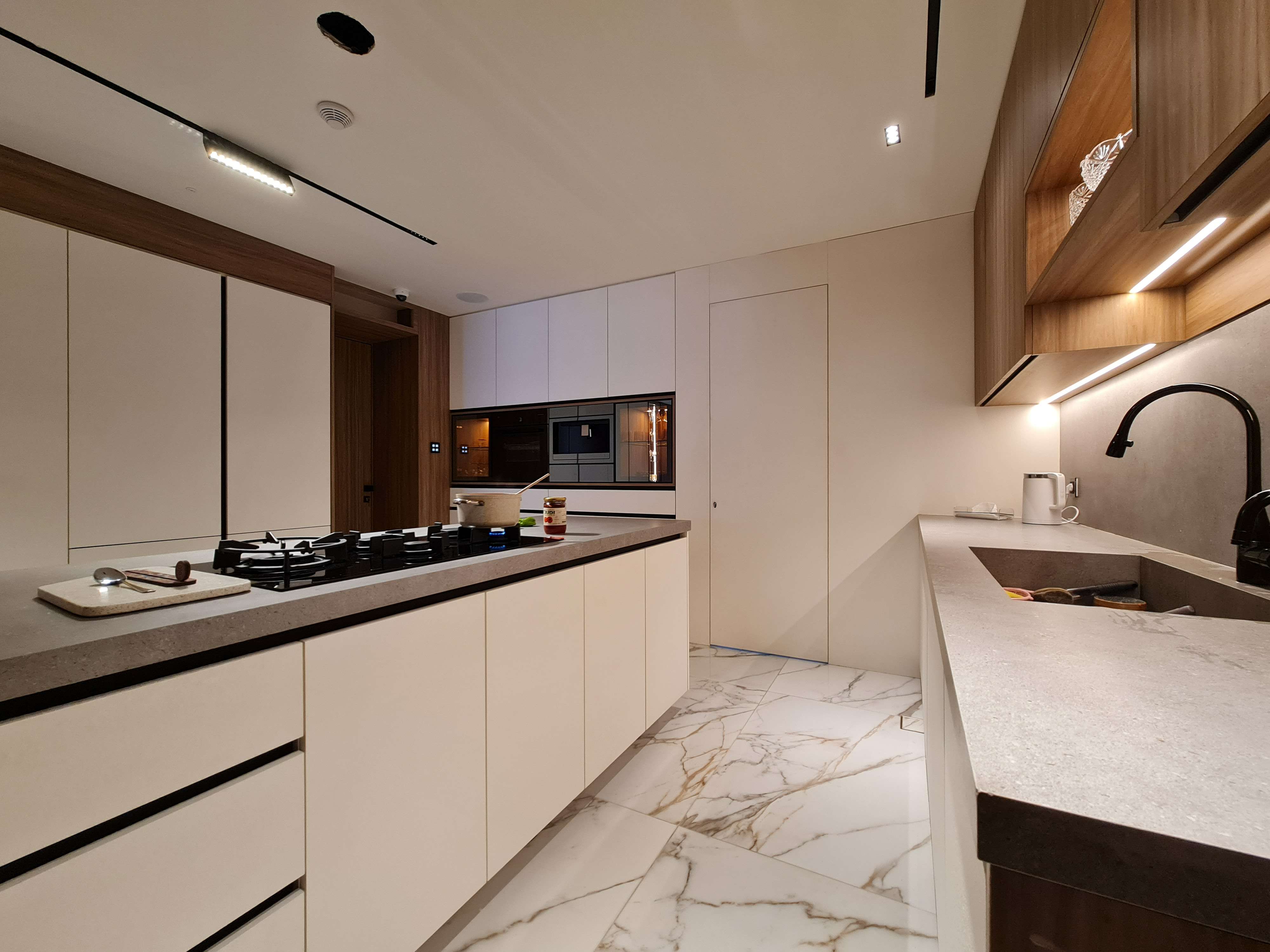 Gourmet kitchen with expansive storage and beautiful fixtures by La Fabriqua