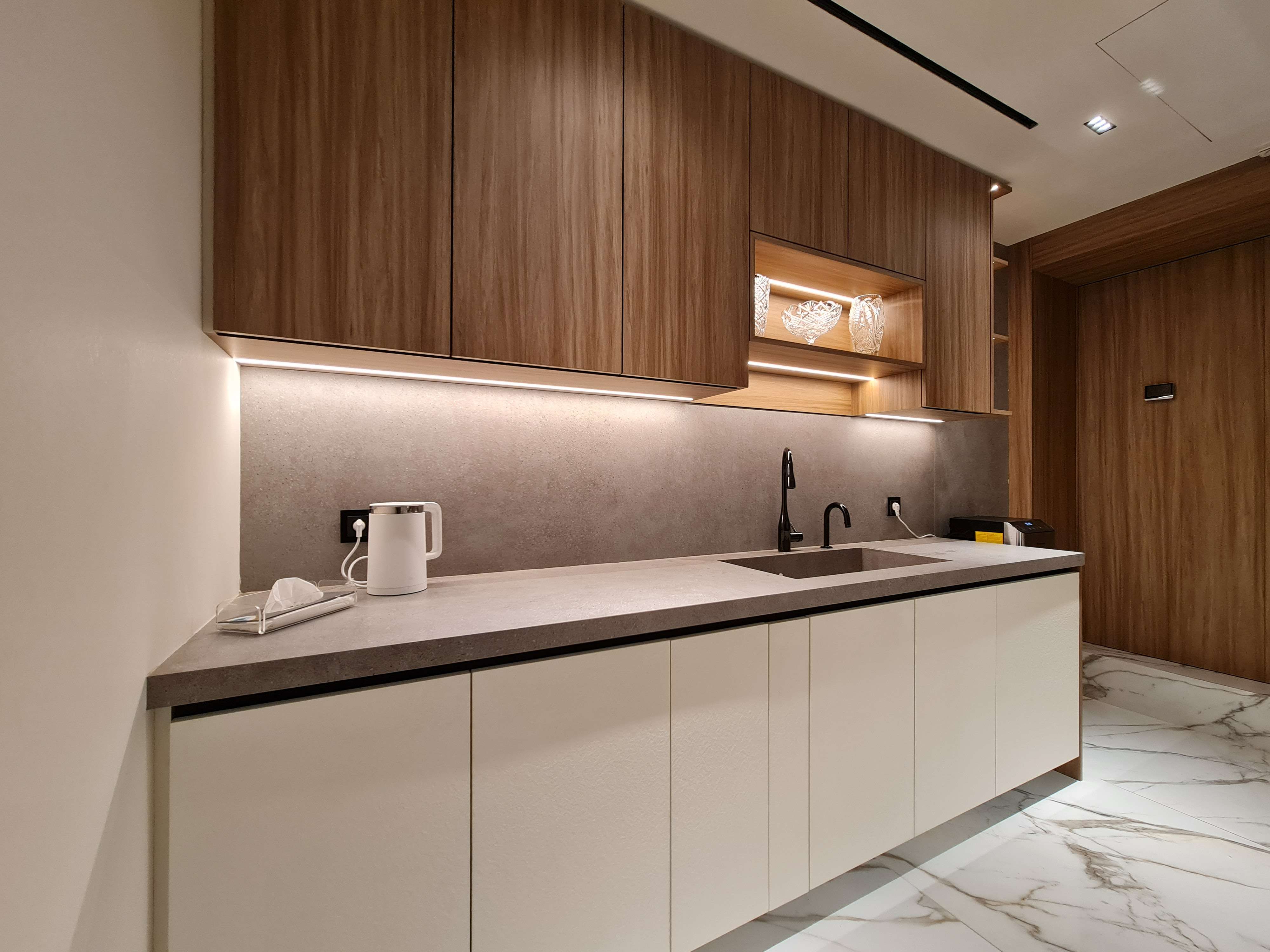 Bright, airy kitchen with stylish lighting and refined design by La Fabriqua