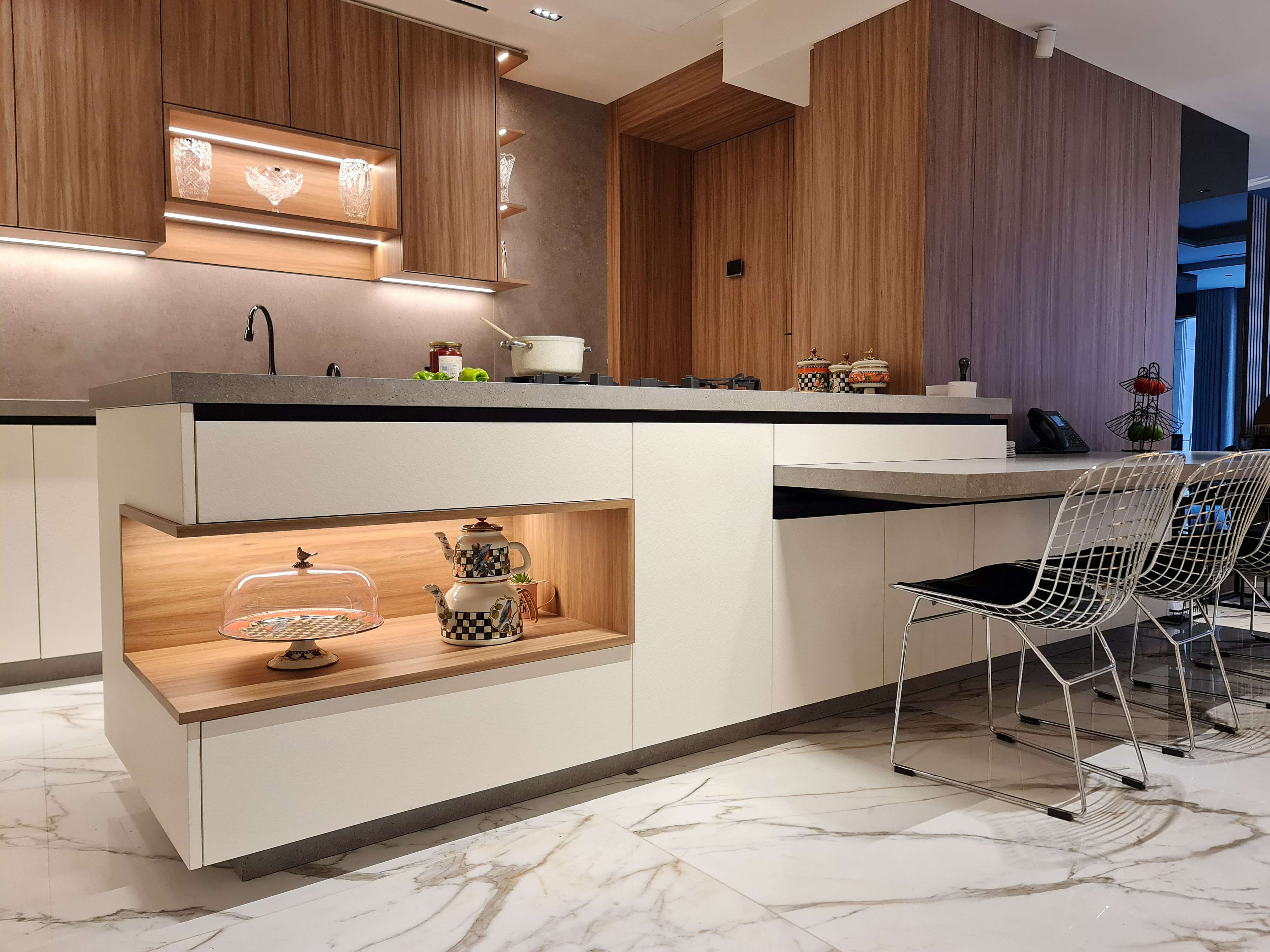 Elegant kitchen featuring marble counters and sophisticated details by La Fabriqua