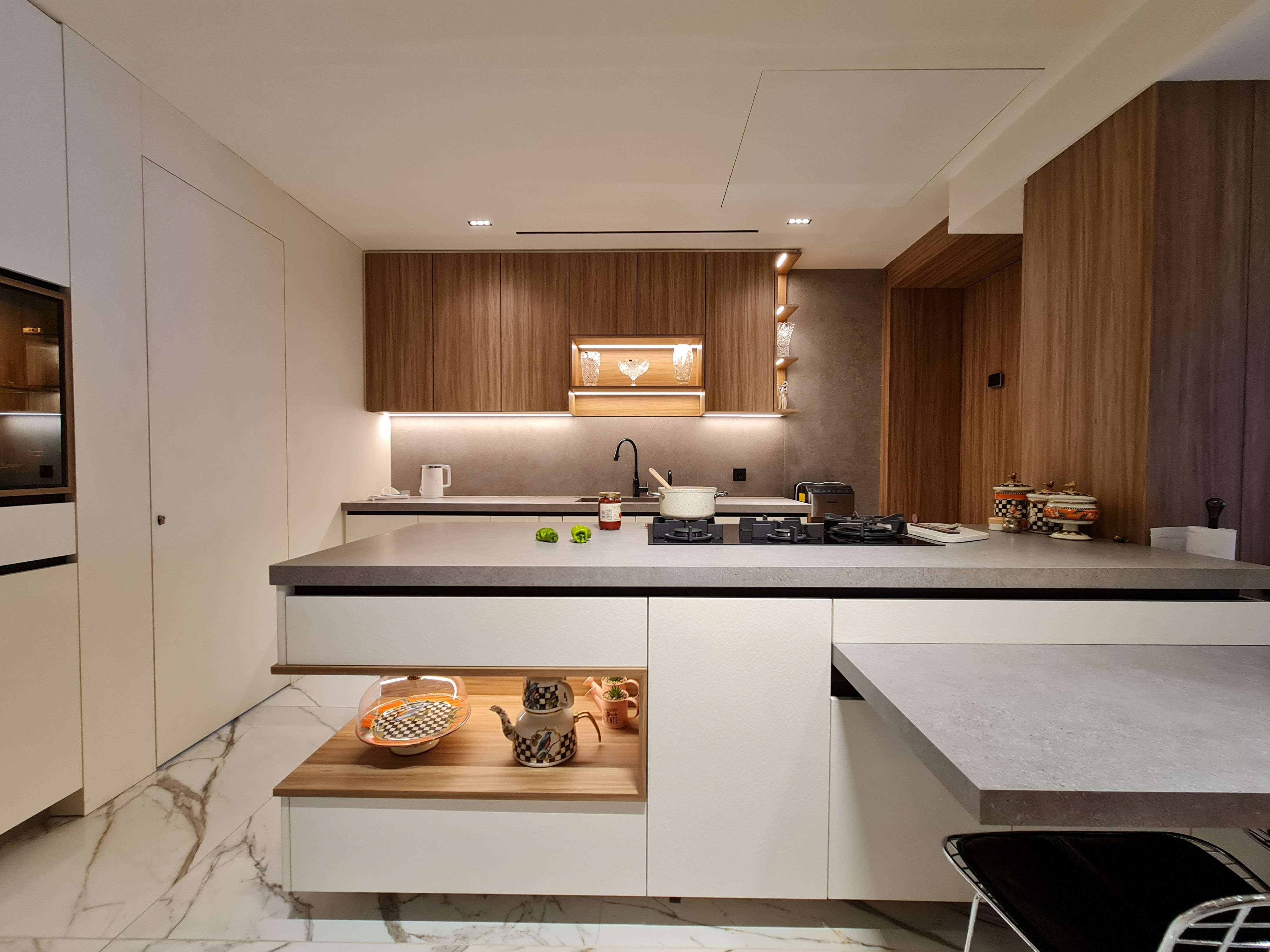 Contemporary kitchen with high-end appliances and unique design elements by La Fabriqua