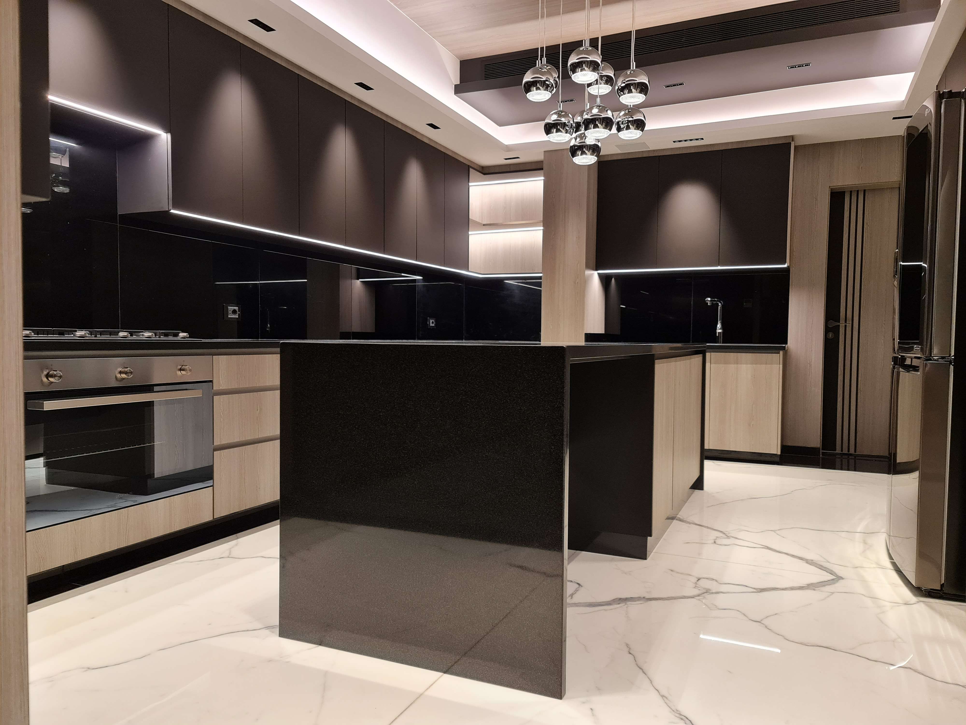 Functional kitchen with efficient storage and elegant lighting design by La Fabriqua